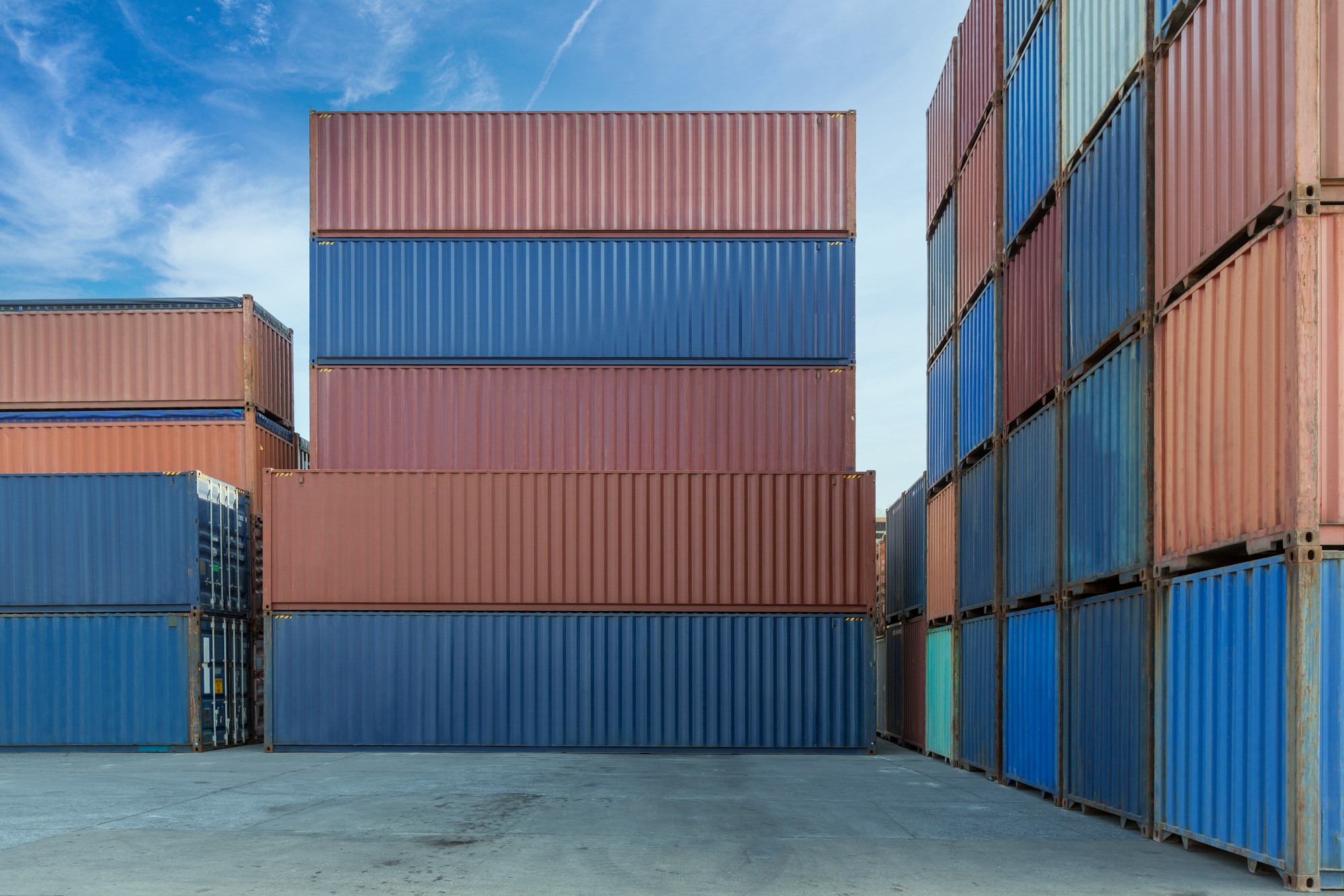 Stack of containers in a harbor. Shipping containers stacked on cargo ship.